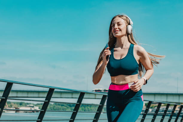 istock Blonde smiling woman running 1232371492