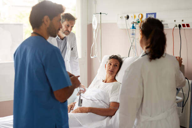 istock A female doctor is talking to a patient lying down on bed. 1232381394