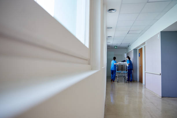 istock Two nurses move a patient on a hospital gurney. 1232384545