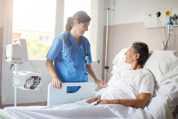 istock A caucassian nurse talking to a patient lying down on bed. 1232391652