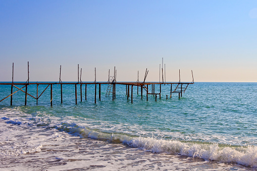 San Vito Chietino - 07-08-2022: The beautiful beach of Calata Turchina with crystal clear and blue sea and the trabocco in background