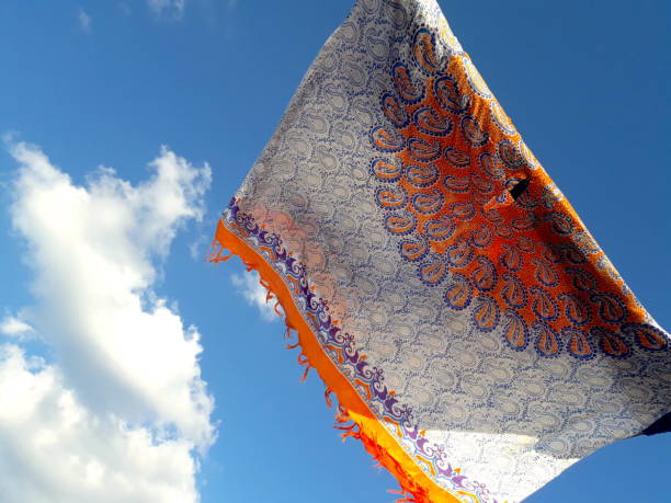 colorful beach sarong and a blue summer sky colorful beach sarong and a blue summer sky sarong stock pictures, royalty-free photos & images