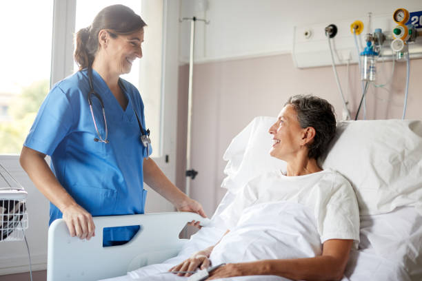 istock A female nurse talking to a patient lying down on bed. 1232415869