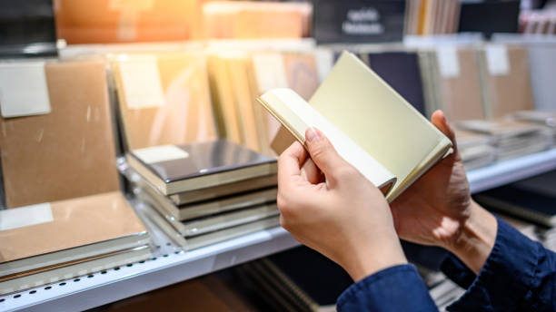 istock Male hand choosing notebook in stationery shop 1232439384