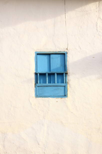 istock Blue simple, rural, and beautiful windows against a white rustic wall 1232452806