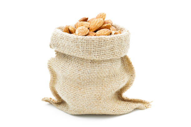 istock Almonds in a sack of cloth on a white background 1232490699