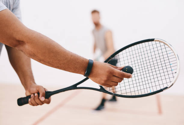 Time to show this ball who's boss Cropped shot of a man serving a ball with a racket during a game of squash squash sport stock pictures, royalty-free photos & images