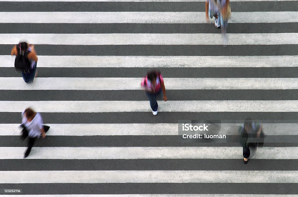 Pedestrian line Five people crossing the street. Unrecognizable people. Zebra Crossing Stock Photo