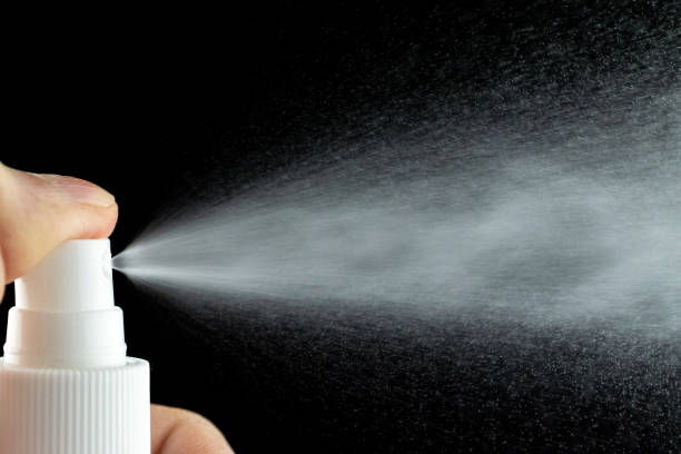 istock Mist spray aerosol bottle for perfume isolated on black. Splash water liquid background. 1232521385