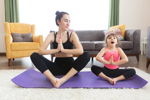 istock Mother and daughter working yoga 1232528146