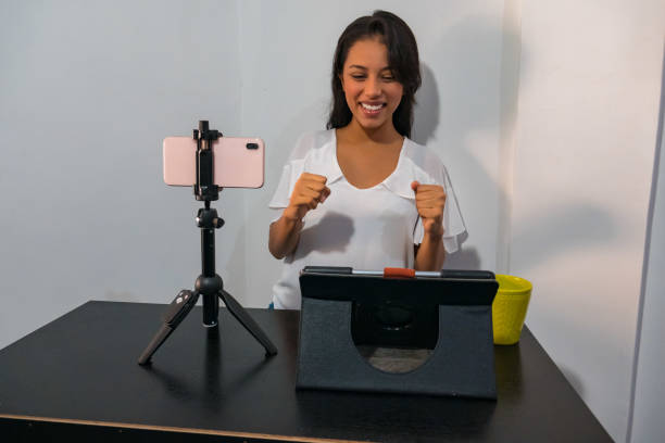 istock Modern technology, internet, blogging, e-commerce and marketing concept Attractive and popular blogger creating new video content for her blog in social networks 1232540406