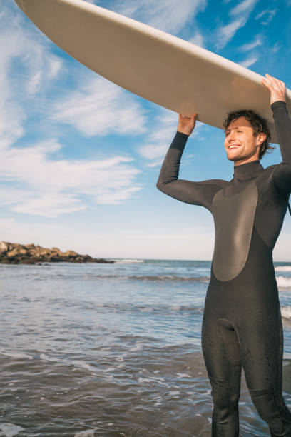 istock Young surfer holding up his surfboard. 1232542479
