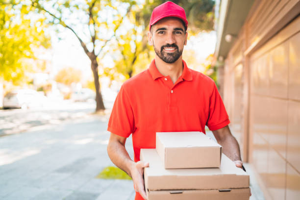 istock Delivery man with pizza box outdoors. 1232543004