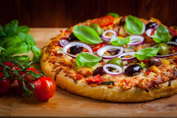 istock Italian cheese pizza with black olives, onions and basil 1232555791