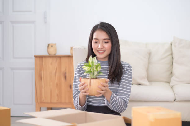 istock Asian woman picking small tree 1232556297