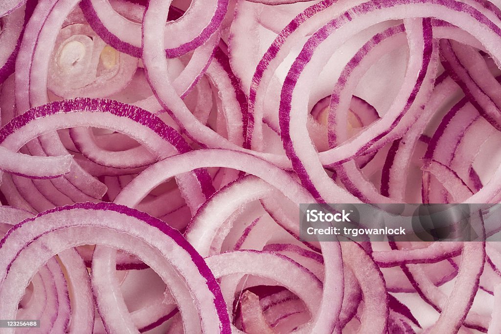 Red onion background Detailed background of overlapping red onion rings Backgrounds Stock Photo