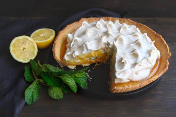 istock Kurdish lemon pie in a black ceramic plate, on a black napkin, on a dark wooden table. 1232567357