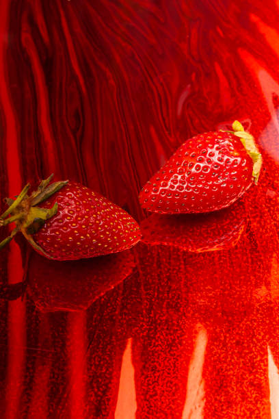 Two fresh tasty strawberries on a art wavy background