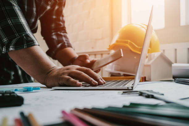 istock Male architect or engineer working at home drawing the construction project. 1232628293