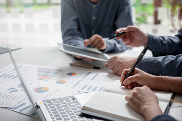 istock Business people working at office with paperwork and using digital tablet. 1232629339