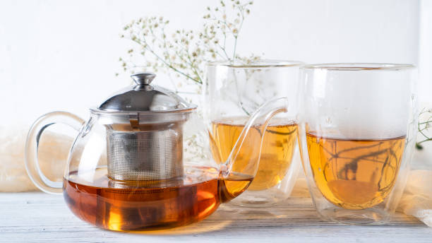 istock Morning romantic tea for couples. Black tea in regular glass teapot. Hot tea in double wall cups. Double walled mugs. 1232651229