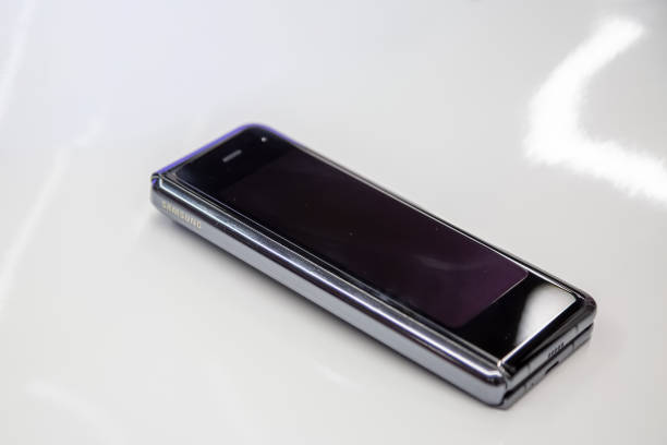 new flagship smartphone Samsung Galaxy Fold with flexible display on white bacground. close up stock photo