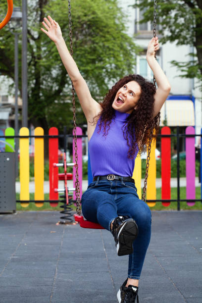 istock Young woman sitting on a swing 1232662538