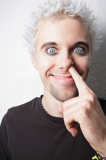 Close-up of wide-eyed silver-haired man picking his nose For more pics of this model click on the images below emo hair guys stock pictures, royalty-free photos & images