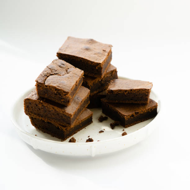 istock Chocolate brownie sliced into square slices on a white plate 1232724239