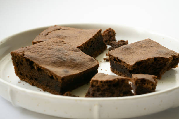istock Chocolate brownie sliced into square slices on a white plate 1232724746