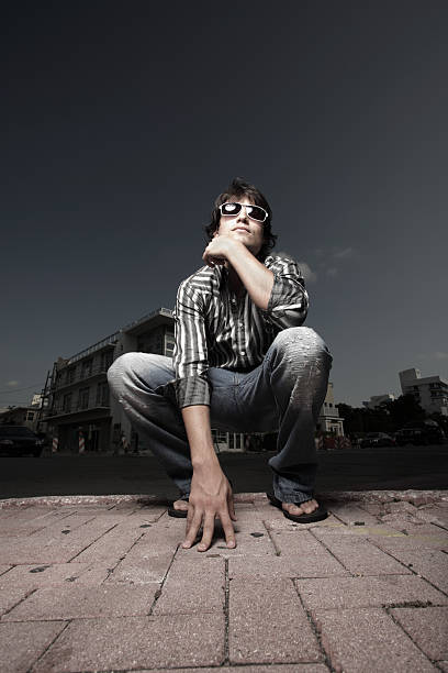 istock Man squatting on the street 123273624