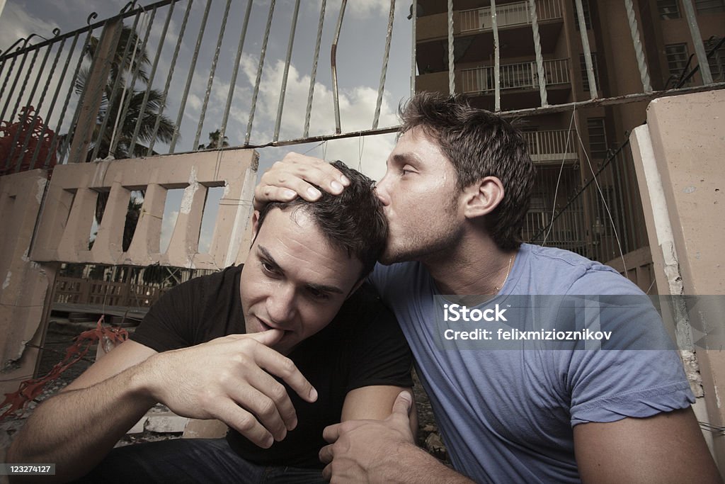 Man comforting his boyfriend Man who just lost his job being comforted by his boyfriend Couple - Relationship Stock Photo