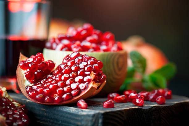 istock Ripe pomegranate fruit on a old black wooden vintage background. Selective focus. 1232770319