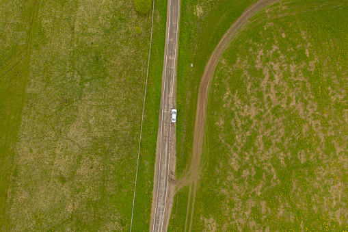 High Angle Aerial View of Rural road with car between green fields, Moscow area, Russia