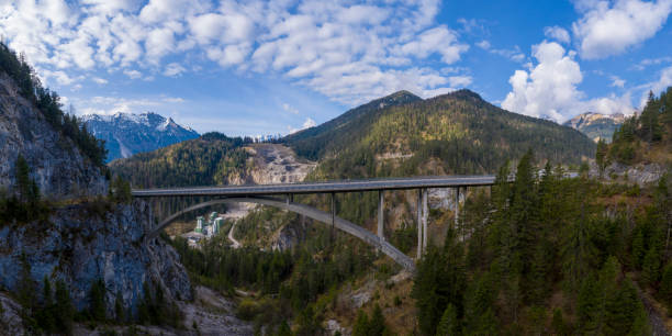 istock view to arch bridge over gaicht valley with view to stone quarry pit between tirol alps 1232794510