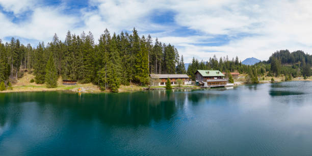 istock Idyllic tranquil Lake Frauensee in spring embedded to forest and cloudy sky 1232801818