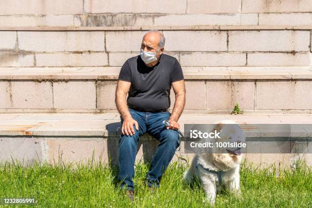 Active Senior Man Lying Down With Dog On The Grasses In Park On Curfew Free Day Under Curfew In Coronavirus Period In Ankara Stock Photo - Download Image Now