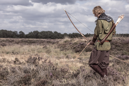 A individual redhead viking archer warrior in the north European countryside