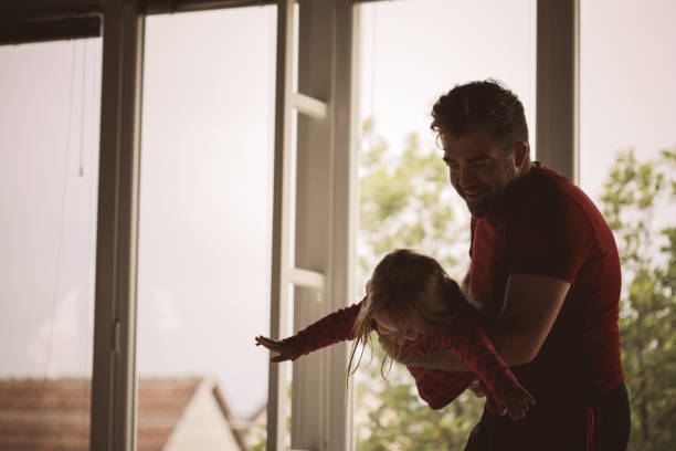 istock Cheerful father enjoying while playing with his little daughter 1232844680