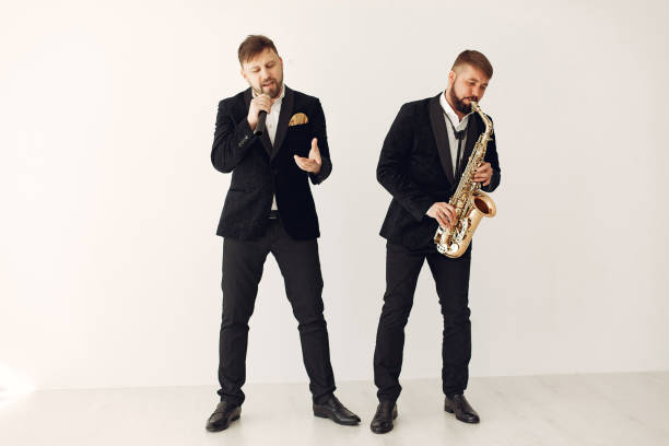 istock Two adult musicians standing in studio 1232850814