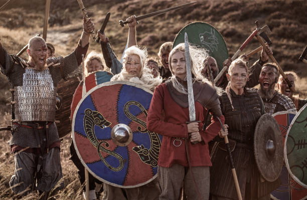 istock Three viking female warrior queens outdoors with a viking hoard 1232872317