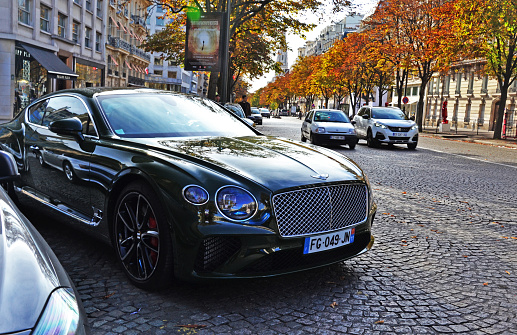 Paris, France - October 26th 2019 : Beautiful green Bentley continental (probably a GT one) stopped in George V avenue.