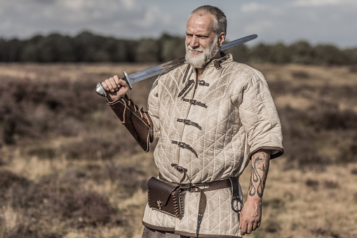 An individual viking warrior man resting on the highland moors