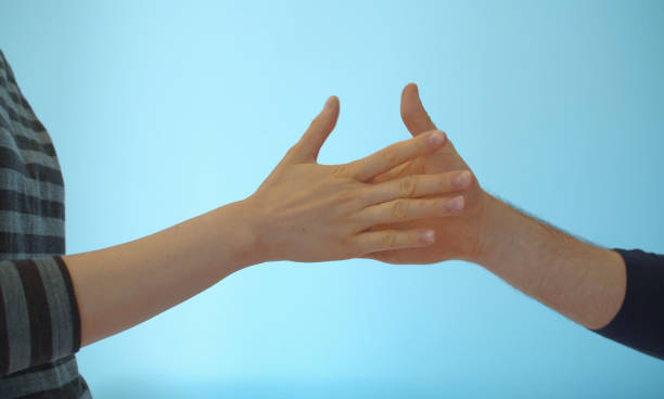 istock Hands of couple playing rock paper scissors 1232891084