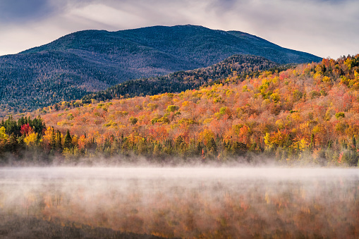 Heart Lake near Lake Placid in the Adirondack Mountains, New York State, USA, on a misty morning during Fall colors.