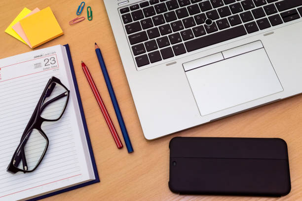 istock Colorful top view of a wooden table during home work 1232970973