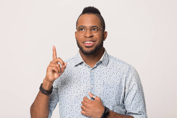 istock Smiling African American man with raise finger isolated, idea concept 1232986716