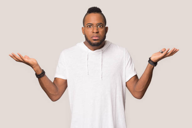 istock Doubtful African American man shrugging shoulders, feeling confused 1232986722