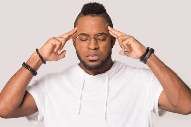 istock Nervous African American man touching temples, relieving headache 1232986769