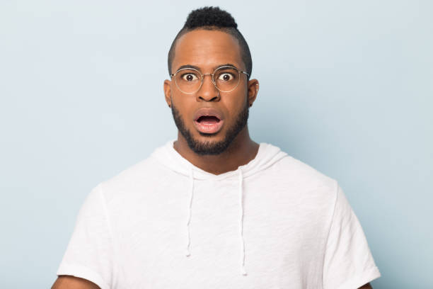 istock Shocked scared African American man in glasses looking at camera 1232986990
